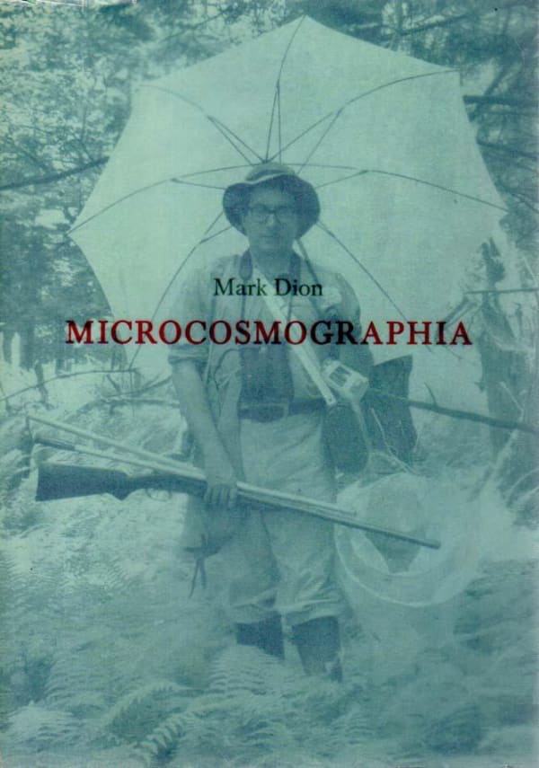 Exhibition catalogue cover. A blue-tinted photo of the artist, a man in glasses wearing safari gear and carrying and umbrella and hunting rifle, walks through brush. Title text: "Mark Dion, Microcosmographia"